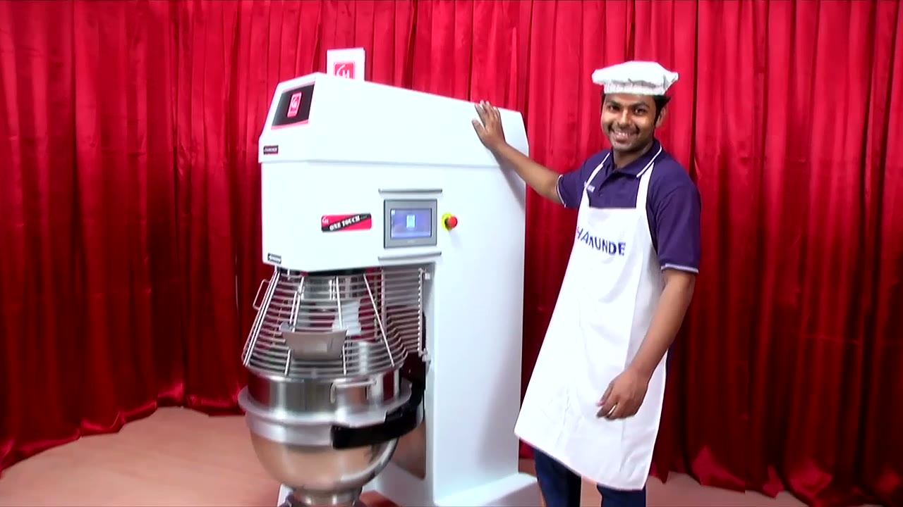 Baker operating a CHAMUNDE planetary mixer