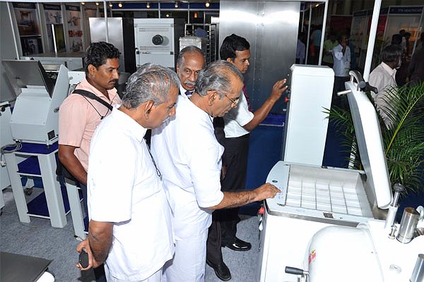 Visitors examining CHAMUNDE equipment at Foodpro