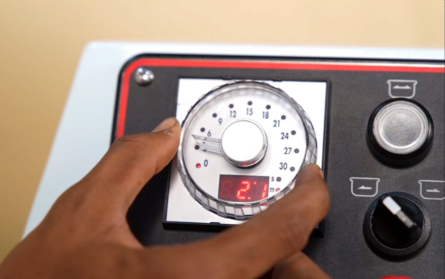 Operator setting the timer dial on a CHAMUNDE spiral mixer